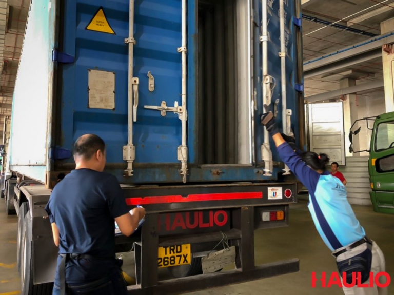 Uncle Foong closing the container door after inspection
